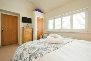 a bedroom with a large bed with two towels on it at Martins Cottage in Alnmouth