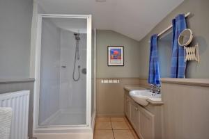 a bathroom with a shower and a sink at Pebble Cottage in Long Houghton