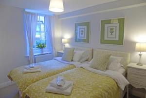 a bedroom with a large bed with towels on it at Dorothy Forster Court in Alnwick