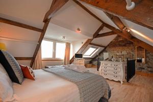 a bedroom with a large bed in a attic at Farne Lookout in Seahouses
