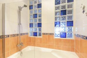 a bathroom with a tub and a glass shower at Farne Lookout in Seahouses +16 photos
