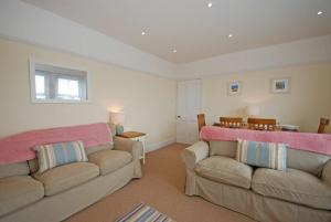 a living room with two couches and a table at Coastal Haven in Seahouses