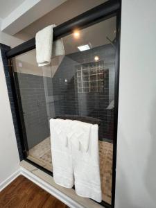 a glass window of a shower with white towels at Cheerful 3 Bedrooms kitchen/dining/private office in Columbus