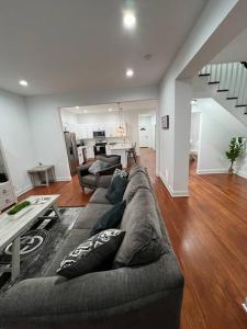 a living room with a couch and a table at Cheerful 3 Bedrooms kitchen/dining/private office in Columbus