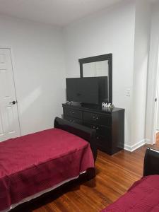 a living room with a red bed and a dresser at Cheerful 3 Bedrooms kitchen/dining/private office in Columbus