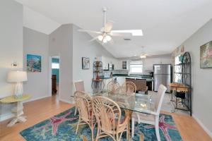 a dining room and kitchen with a glass table and chairs at Siesta-Retreats - Key West Unit in Siesta Key
