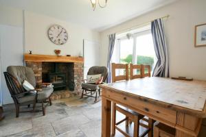 a living room with a table and a fireplace at Inveray in Seahouses