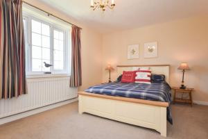 a bedroom with a bed and a large window at Inveray in Seahouses