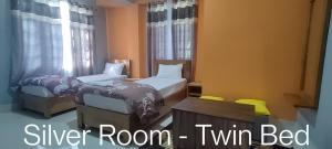 a bedroom with two beds and a twin bed at Monshing Homestay - Elevate your travel experience in Bomdila