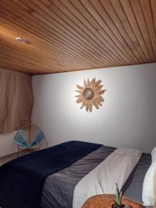 a bedroom with a bed with a sun sign on the wall at Naturaleza, Descanso y Fogata, Casa de Campo Romeros in Iza
