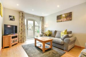 a living room with a couch and a tv at East Havers in Alnwick
