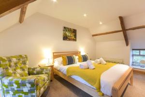 a bedroom with a bed and a chair at East Havers in Alnwick