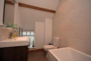 a bathroom with a sink and a toilet and a tub at East Havers in Alnwick +10 photos