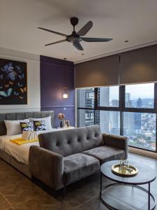 a living room with a couch and a ceiling fan at Scarletz Suites KLCC by Mana-Mana in Kuala Lumpur +37 photos