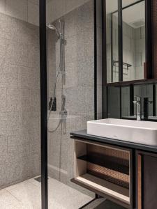 a bathroom with a sink and a shower at Scarletz Suites KLCC by Mana-Mana in Kuala Lumpur