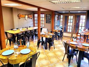 a dining room with tables and chairs in a restaurant at Morrena Lodge in Torres del Paine +42 photos