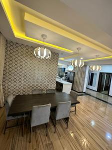 a kitchen and dining room with a table and chairs at Nigus House Oniru in Lagos +10 photos