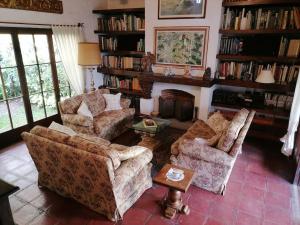 a living room with two couches and a fireplace at La Casa de la Abuela in Antigua Guatemala