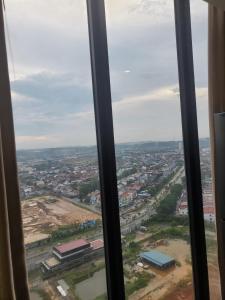 a view of a city from a window at Alexa Meisterstadt pollux habibie in Batam Center