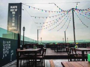 a restaurant with tables and chairs and flags at Norvinton Hotel in Batu Pahat