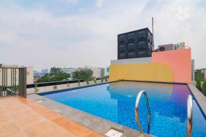 a swimming pool on the roof of a building at Sans Hotel Alexander Bandung in Bandung