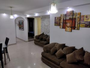 a living room with two couches and a dining room at Apartamento frente al Aeropuerto de Maiquetía in Maiquetía