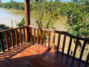a wooden porch with a view of a river at Floor river view in Cat Tien
