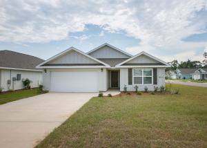 a large white house with a garage at Grand Getaway House in Foley