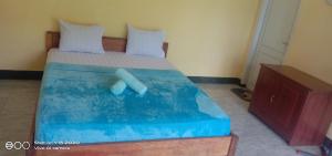 a bedroom with a bed with a pool at Achita Cottages in Senaru