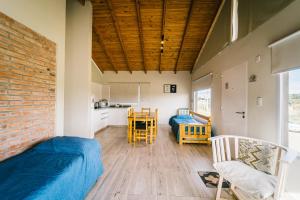 ein Zimmer mit zwei Betten und einer Ziegelwand in der Unterkunft Balcón del Cerro in Sierra de la Ventana