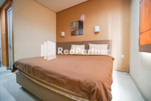 Postel nebo postele na pokoji v ubytování Tirta Mansion Lippo Karawaci Mitra RedDoorz