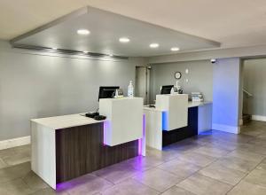 an office with two reception desks with purple lights at La Quinta Inn by Wyndham El Paso East Lomaland in El Paso