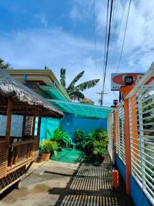 a house with a blue facade and a patio at R&D Traveller's Inn in Anda +9 photos
