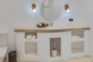 a bathroom with a sink and a mirror at Ampersand Resort in Bophut 