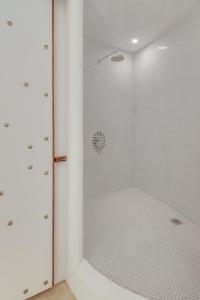 a shower with a glass door in a bathroom at Ampersand Resort in Bophut 