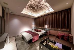 Ένα ή περισσότερα κρεβάτια σε δωμάτιο στο Hotel Cocoon -Urban Luxury-