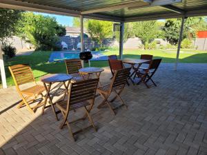 a group of chairs and tables on a patio at Ayana bnb in Bloemfontein