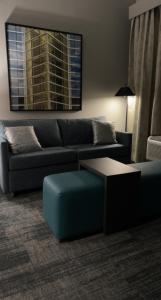 a living room with a couch and a table at Homewood Suites By Hilton Oklahoma City Quail Springs in Oklahoma City