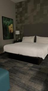 a bedroom with a large bed with white sheets at Homewood Suites By Hilton Oklahoma City Quail Springs in Oklahoma City