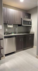 a kitchen with a sink and a microwave at Homewood Suites By Hilton Oklahoma City Quail Springs in Oklahoma City