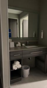 a bathroom with a sink and a mirror at Homewood Suites By Hilton Oklahoma City Quail Springs in Oklahoma City
