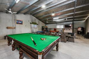 a pool table in a room with a green table at Mudgee Valley Park in Mudgee