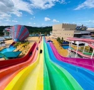 a roller coaster at a amusement park with a rainbow colored track at Vista Bangi Soho UKM, Swimming pool & River view in Kajang