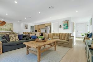a living room with a couch and a table at Manzi Jervis Bay in Huskisson