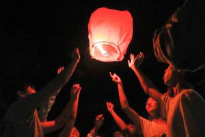 a group of people with their hands in the air with a red lantern at Hoya Spa Hotel in Ruisui +88 photos
