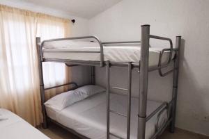 a couple of bunk beds in a room at Casa Loma Flamingos Ixtapa in Ixtapa