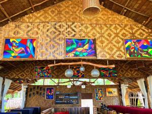 a room with colorful paintings on the wall at Prince John beachfront cottages and Restaurant in San Vicente