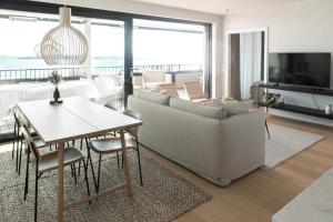 a living room with a couch and a table at Suite Portus - Design apartment by the sea in Hanko