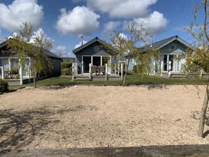 a house with a yard in front of it at Blue Anchor Retreat, The Bay, two bedrooms with ensuites, parking for 2 cars, 2 dogs welcome in Filey