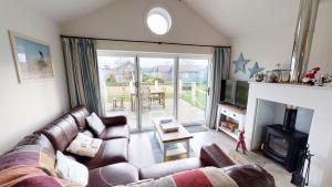 a living room with a couch and a fireplace at Blue Anchor Retreat at The Bay Filey, sleeps 4, 2 dogs welcome for free too in Filey